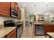Charming kitchen with stainless steel appliances, granite countertops, and wood cabinetry at 3391 Cortland Dr, Davenport, FL 33837