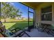 Relaxing screened-in lanai with comfortable seating and scenic views of the backyard and beyond at 3391 Cortland Dr, Davenport, FL 33837