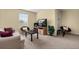 Comfortable living room area with neutral walls, carpeted floor, and an entertainment center at 3391 Cortland Dr, Davenport, FL 33837