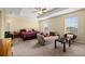 Large main bedroom with a trey ceiling, carpeted floors, natural light, and cozy sitting area at 3391 Cortland Dr, Davenport, FL 33837