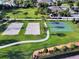 Aerial view of recreational facilities, featuring a basketball court and two sand volleyball courts at 341 Lasso Dr, Kissimmee, FL 34747