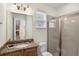 Bathroom featuring granite countertops, a glass-enclosed shower, and a vanity with good lighting at 341 Lasso Dr, Kissimmee, FL 34747