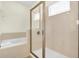 Modern bathroom featuring a glass-enclosed shower and separate soaking tub at 341 Lasso Dr, Kissimmee, FL 34747
