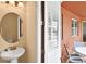 Cozy powder room near the outdoor patio with a pedestal sink at 341 Lasso Dr, Kissimmee, FL 34747