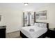 Well-lit bedroom with a large window, carpet floors, and simple furnishings at 341 Lasso Dr, Kissimmee, FL 34747