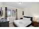 Comfortable bedroom with carpet, a black bed frame, and a window offering natural light at 341 Lasso Dr, Kissimmee, FL 34747