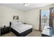 Comfortable bedroom featuring a queen bed, neutral decor, and a bright window at 341 Lasso Dr, Kissimmee, FL 34747