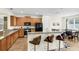 Well-equipped kitchen featuring a breakfast bar, wood cabinetry, and modern appliances at 341 Lasso Dr, Kissimmee, FL 34747