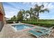 Private swimming pool surrounded by lounge chairs and lush landscaping at 341 Lasso Dr, Kissimmee, FL 34747