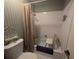 Small bathroom featuring a shower and tub combination with tiled walls and blue wallpaper at 4345 Old Colony Rd, Mulberry, FL 33860