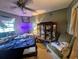 Cozy bedroom with a large window, a ceiling fan, and furnishings at 4345 Old Colony Rd, Mulberry, FL 33860