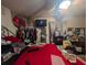 Bedroom featuring a red bedspread and cluttered surrounding with a TV on the wall at 4345 Old Colony Rd, Mulberry, FL 33860