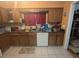 Bright kitchen features wood cabinets, a stainless steel dishwasher, and a window at 4345 Old Colony Rd, Mulberry, FL 33860