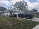 Side of the home with a two-car garage and a truck parked in the driveway at 4345 Old Colony Rd, Mulberry, FL 33860