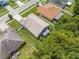 Aerial view of the rear of a house with a fenced yard and mature trees at 4726 Ashurst St, Kissimmee, FL 34758
