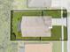 Aerial view of a fenced property with a well-maintained roof, landscaping, and a driveway at 4726 Ashurst St, Kissimmee, FL 34758