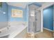 Bathroom with a large soaking tub, and a glass-enclosed shower at 4726 Ashurst St, Kissimmee, FL 34758