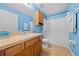 Cozy bathroom with blue walls, tiled floors, vanity, and tub at 4726 Ashurst St, Kissimmee, FL 34758