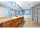 Bathroom with a double sink vanity, a large soaking tub, and a glass-enclosed shower at 4726 Ashurst St, Kissimmee, FL 34758