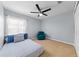 Cozy bedroom with a ceiling fan, a large bed, and a window overlooking the front yard at 4726 Ashurst St, Kissimmee, FL 34758