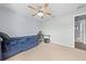 A well lit bedroom with carpeting, a ceiling fan, and a desk at 4726 Ashurst St, Kissimmee, FL 34758