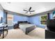 Bedroom featuring a ceiling fan, a desk, and two windows overlooking the backyard at 4726 Ashurst St, Kissimmee, FL 34758