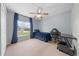 A well lit bedroom with carpeting, a ceiling fan, and a street view at 4726 Ashurst St, Kissimmee, FL 34758