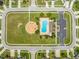 Overhead view of community amenities featuring a pool and playground in a Gathering-friendly neighborhood setting at 4726 Ashurst St, Kissimmee, FL 34758