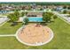 Aerial view of community amenities including a swimming pool and playground surrounded by lush greenery at 4726 Ashurst St, Kissimmee, FL 34758