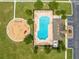 Bird's eye view of the community pool and playground with ample lounge seating and shade trees at 4726 Ashurst St, Kissimmee, FL 34758