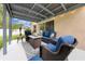 A cozy covered patio with a fire pit and comfortable seating at 4726 Ashurst St, Kissimmee, FL 34758