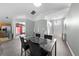 Bright dining area displays a modern table setting, tile flooring, and views of the front entryway at 4726 Ashurst St, Kissimmee, FL 34758