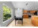 Bright eat-in kitchen area offering a modern table and seating, with a large window providing natural light at 4726 Ashurst St, Kissimmee, FL 34758