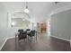 An open-concept dining area showcases a modern glass table, tile floors, and elegant architectural details at 4726 Ashurst St, Kissimmee, FL 34758