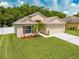 Well-maintained home with a lush lawn, a two-car garage, and lovely landscaping at 4726 Ashurst St, Kissimmee, FL 34758