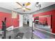 A home gym with mirrors, exercise equipment, and yoga mats at 4726 Ashurst St, Kissimmee, FL 34758