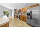 Spacious kitchen features stainless steel appliances, light wood cabinets, and recessed lighting at 4726 Ashurst St, Kissimmee, FL 34758