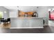 Eat-in kitchen with stainless appliances and light wood cabinets overlooks the workout area at 4726 Ashurst St, Kissimmee, FL 34758