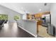Open-concept kitchen with light wood cabinets, stainless appliances, and a breakfast bar at 4726 Ashurst St, Kissimmee, FL 34758