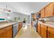 Bright eat-in kitchen features light wood cabinets, stainless appliances, and mosaic tile backsplash at 4726 Ashurst St, Kissimmee, FL 34758
