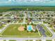 Aerial view of the residential neighborhood featuring community playground and pool surrounded by homes at 4726 Ashurst St, Kissimmee, FL 34758