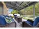 Relaxing covered patio featuring comfortable seating and a modern gas fire pit with views of the serene backyard at 4726 Ashurst St, Kissimmee, FL 34758