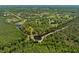 Scenic aerial view of a wooded property with ponds and scattered homes in a peaceful, rural setting at 4730 Cypress Creek Ranch Rd, St Cloud, FL 34771