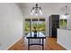 Inviting dining area features outdoor view, dark table and access to the kitchen, perfect for gatherings at 4730 Cypress Creek Ranch Rd, St Cloud, FL 34771