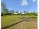 Expansive front lawn with a single-story home in the background, featuring a light-blue facade and covered porch at 4730 Cypress Creek Ranch Rd, St Cloud, FL 34771