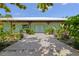 This charming home has a light-blue facade, covered porch with rustic wooden beams, and lush landscaping at 4730 Cypress Creek Ranch Rd, St Cloud, FL 34771