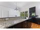 Stylish kitchen features speckled granite countertops, dark cabinets, stainless steel appliances, and bright natural light at 4730 Cypress Creek Ranch Rd, St Cloud, FL 34771