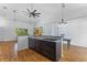 Spacious kitchen featuring dark wood cabinetry, granite countertops, stainless steel appliances, and hardwood floors at 4730 Cypress Creek Ranch Rd, St Cloud, FL 34771