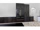 Modern kitchen featuring stainless steel refrigerator, dark wood cabinets, and granite countertops, perfect for cooking and entertaining at 4730 Cypress Creek Ranch Rd, St Cloud, FL 34771