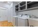 Laundry room with modern appliances, sink, and ample storage at 4730 Cypress Creek Ranch Rd, St Cloud, FL 34771